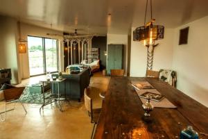 a living room with a large wooden table and chairs at Stunning Lone Pine Accommodation for Romantic Getaways in California in Lone Pine