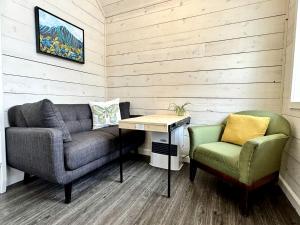 a living room with a couch and a chair at Gorgeous Tiny Cabin Placed in a Privileged Area in Anchorage, Alaska in Chugiak
