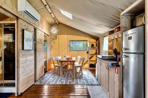 a kitchen and dining area of a tiny house at Incredible Tented Cabin with Fire Pit and Hot-tub in Sevierville, Tennessee in Wear Valley