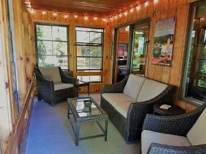 a living room with chairs and a couch and a table at Inviting Lakefront Cabin with a Private Dock in Boulder Junction, Wisconsin in Boulder Junction