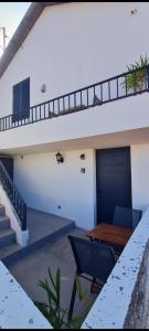 a patio with a wooden table and a garage at Refúgio das Regadinhas in Santa Cruz +17 photos