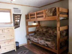 a bedroom with two bunk beds and a dresser at Rustic Mountain Retreat Perfect for Large Groups in Kingston, Idaho in Smelterville