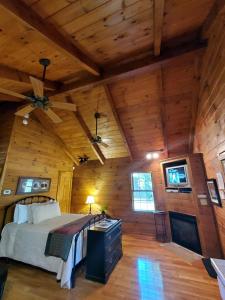 a bedroom with a bed in a wooden cabin at Cozy Riverside Cabin Retreat Near New River, Virginia in Galax
