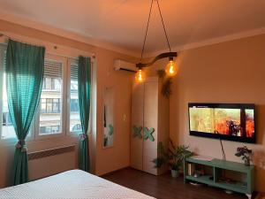 a bedroom with a bed and a flat screen tv at Obilic L - City View apartment in Pedestrian Zone in Belgrade