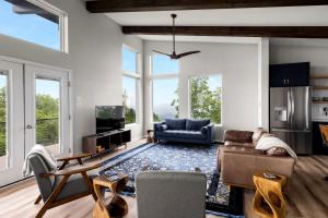 a living room with a couch and a table at Scenic Getaway Cabin w/ Fire Pit, Deck & Panoramic Views in Martinsburg, WV in Martinsburg