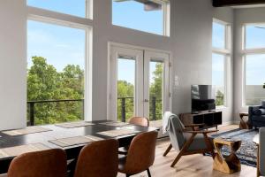 a dining room with a table and chairs and windows at Scenic Getaway Cabin w/ Fire Pit, Deck & Panoramic Views in Martinsburg, WV in Martinsburg +52 photos