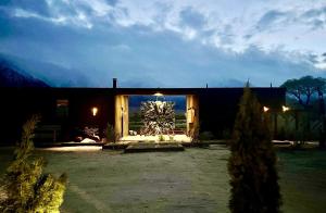 a house with a large window in a yard at Luxury Design Rental with Breathtaking Mountain Views in Lone Pine, California in Lone Pine