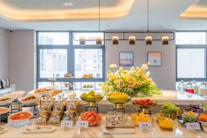 a buffet with fruits and vegetables on a table at Atour Hotel Wuxi Huishan Wanda Plaza in Wuxi