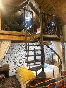 a room with a bunk bed and a spiral staircase at Go Glamping in Athens, Georgia, in this Cozy Tiny House for Four in Athens