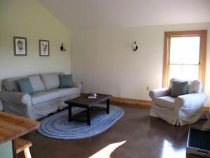 a living room with two couches and a coffee table at Elegant Cabin Rental on a Hillside Farm in Hartland, Vermont in Sheddsville