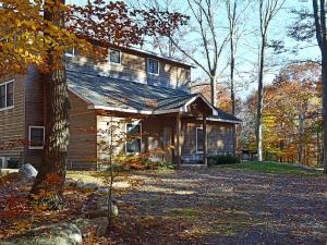 a house with a tree in front of it at Enormous Family-Friendly Cabin Rental in Shawangunk Mountains, New York in Pine Bush