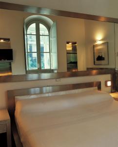 a hotel room with two beds and a large window at Villa Laetitia in Rome