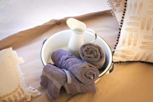 a container with towels and a bottle on a table at Luxurious Tent Vacation Rental on Glamping Site near Salem, Oregon in Jefferson
