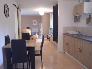 a kitchen and living room with a table and chairs at Gite a Firmi in Firmi