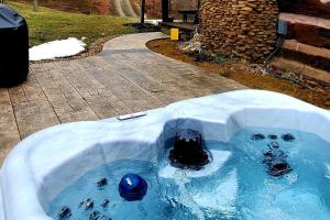 a jacuzzi tub with a ball in it at Renovated Cottage with Spa Surrounded by Beautiful Hiking Trails in Ohio in Deersville