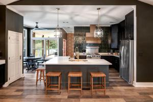 a kitchen with a large island with bar stools at Stunning Rental with Hot-Tub, Theater Room and Great Landscape in Tennessee in Waldens Creek
