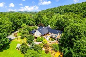 an aerial view of a large house in the woods at Stunning Rental with Hot-Tub, Theater Room and Great Landscape in Tennessee in Waldens Creek +86 photos