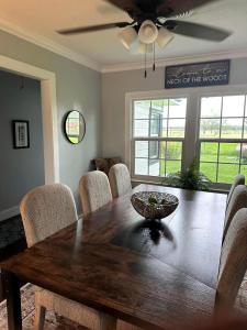 a dining room table with chairs and a ceiling fan at Spectacular Secluded Cottage in Round Top, Texas in Ledbetter