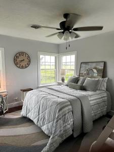 a bedroom with a bed and a clock on the wall at Spectacular Secluded Cottage in Round Top, Texas in Ledbetter