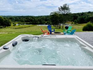 a jacuzzi tub with chairs in a yard at Incredible A-frame with Fabulous Panoramic Views and Hot-tub in Makanda, Illinois in Goreville