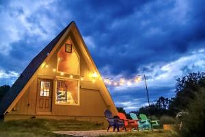 a group of chairs sitting outside of a house at Incredible A-frame with Fabulous Panoramic Views and Hot-tub in Makanda, Illinois in Goreville