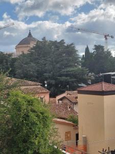 een groep gebouwen en bouwkranen in een stad bij Una finestra su San Bernardino in LʼAquila +11 foto's
