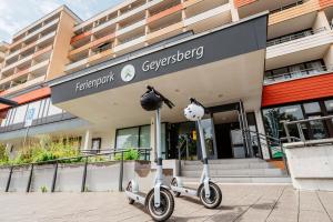 two scooters parked in front of a building at Ferienpark Geyersberg inklusive aktivCARD Bayerischer Wald in Freyung