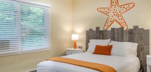 a bedroom with a bed with a starfish on the wall at Tranquil Lakefront Cottage with Private Dock in Ticonderoga, New York in Glenburnie