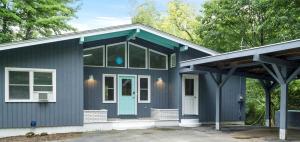 a blue house with a blue door and windows at Tranquil Lakefront Cottage with Private Dock in Ticonderoga, New York in Glenburnie