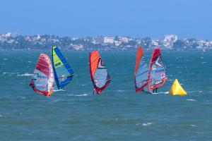 a group of wind sailboats in the water at MUINE MOMO Homestay in Ấp Khánh Phước (1)