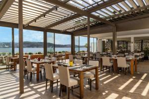 a restaurant with tables and chairs and a view of the water at Radisson Blu Bosphorus Hotel in Istanbul