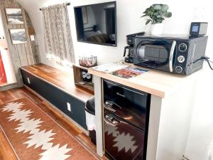 La cuisine est équipée d'un four micro-ondes et d'un four traditionnel. dans l'établissement Sleek, Modern Airstream in Grand Junction, Ideal for Colorado Glamping Escapes, à Grand Junction