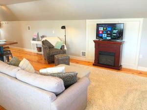 a living room with a couch and a flat screen tv at Stylish Cottage Loft Rental on a Farm in Lancaster County near Philadelphia, Pennsylvania in Christiana