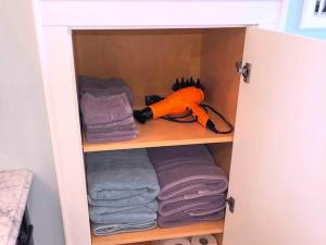 a cupboard with towels and a toy in it at Stylish Cottage Loft Rental on a Farm in Lancaster County near Philadelphia, Pennsylvania in Christiana
