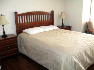 a bedroom with a large bed with two night stands at Unique Renovated Barn Rental with Pond near Cooperstown, New York in Fly Creek