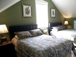 a bedroom with two beds and a window at Enchanting Cabin Rental near Colorado Springs, Colorado in Westcreek +28 photos