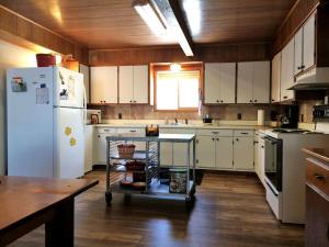 a kitchen with white appliances and a white refrigerator at Lakefront Cottage Rental with Game Room near Ruth Lake, Minnesota in Emily