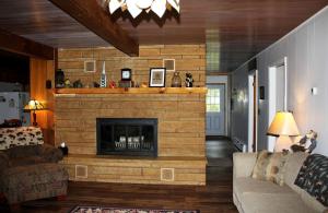 a living room with a fireplace in a house at Lakefront Cottage Rental with Game Room near Ruth Lake, Minnesota in Emily