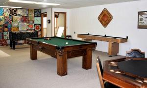 a room with a pool table and two tables at Lakefront Cottage Rental with Game Room near Ruth Lake, Minnesota in Emily +31 photos