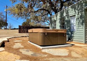 a large wooden box sitting outside of a building at Efficiency-Style Cabin with Spa Lovely for a Couples Escape in Hunt, Texas in Hunt +32 photos