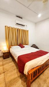 a bedroom with a large bed in a room at TS Club in Trichūr