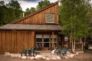 a cabin with a table and chairs in front of it at Eco-Friendly Cabin with Views of the Rocky Mountains in Colorado in Monarch