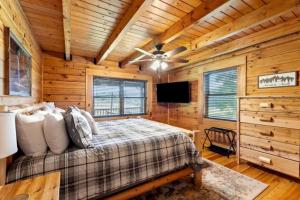a bedroom with a bed and a ceiling fan at Stunning Cabin with Hot-tub, Fire Pit and Games in Stanton, Kentucky in Stanton