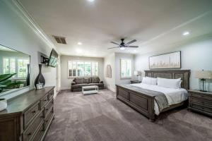 a large bedroom with a bed and a couch at Impressive Luxurious Rental with Pool and Game Space in NC in Charlotte