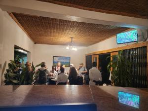 a group of people sitting around a table in a room at Hotel ikoro in Nyakabande