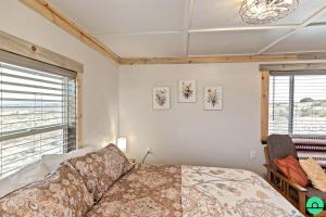 a bedroom with a bed and a large window at Rustic Secluded Cabin with Stunning Sights in Monticello, Utah in Monticello