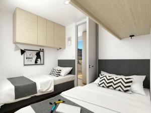 two beds in a small room with white walls at Magical Retreat with a Pool Ideal for Luxury Camping, Austria in Unterlibitsch