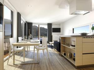 a kitchen and dining room with a table and chairs at Magical Retreat with a Pool Ideal for Luxury Camping, Austria in Unterlibitsch