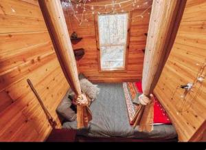 an inside view of a room in a log cabin at Enchanting Tree House with a Slide on 200 Acres for a Family Adventure in Germantown, Kentucky in Germantown