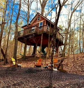 a tree house in the middle of the woods at Enchanting Tree House with a Slide on 200 Acres for a Family Adventure in Germantown, Kentucky in Germantown